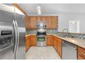 Well-equipped kitchen with stainless steel appliances, wooden cabinets, and tiled backsplash at 23456 E 5Th Pl # 104, Aurora, CO 80018