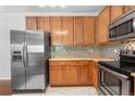 Updated kitchen featuring stainless steel appliances, granite countertops, and ample cabinet space at 23456 E 5Th Pl # 104, Aurora, CO 80018