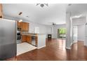 Open-concept living area with hardwood floors, a fireplace, and sliding glass doors to a private balcony at 23456 E 5Th Pl # 104, Aurora, CO 80018