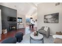 Cozy living room with a fireplace, large windows, hardwood floors, and a dining area view at 345 Fillmore St # 409, Denver, CO 80206