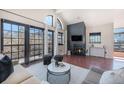 Spacious living room featuring a fireplace, large windows with city views, and hardwood floors at 345 Fillmore St # 409, Denver, CO 80206