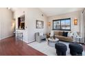 Bright living room featuring an open floor plan, modern furniture, hardwood floors and stylish decor at 345 Fillmore St # 409, Denver, CO 80206