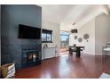 This stylish living room boasts a fireplace and large windows, with wood floors at 345 Fillmore St # 409, Denver, CO 80206