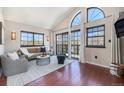 Open living room with high ceilings, large windows, hardwood floors, and contemporary furnishings at 345 Fillmore St # 409, Denver, CO 80206