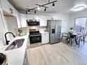 Modern kitchen boasts stainless steel appliances, white cabinetry, and sleek countertops at 5721 W 92Nd Ave # 66, Westminster, CO 80031