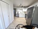 Stylish kitchen with stainless steel appliances, white cabinets, and modern track lighting at 5721 W 92Nd Ave # 66, Westminster, CO 80031