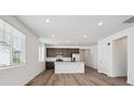Bright open-concept kitchen featuring stainless steel appliances and a center island at 2668 Simpson Ln, Erie, CO 80026