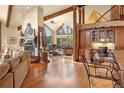 Open living space with hardwood floors and a fireplace at 187 Fox Ridge Dr, Evergreen, CO 80439