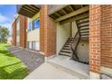 Exterior apartment stairs showcasing brick accents and well-kept landscaping at 3653 S Sheridan Blvd # 16, Denver, CO 80235