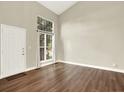 Bright, open living room with hardwood floors, large window, and tall ceilings at 19897 E Brunswick Dr, Aurora, CO 80013