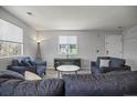 Bright living room featuring neutral walls, plush gray sofas, and ample natural light from multiple windows at 3228 W Girard Ave # C, Englewood, CO 80110