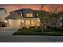 Inviting two-story home featuring a well-manicured lawn and a two-car garage at 8179 S Kellerman Cir, Aurora, CO 80016