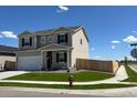 View of a modern two-story home with well-maintained lawn and a side-entry garage at 2204 Alyssa St, Fort Lupton, CO 80621