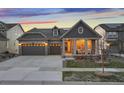 Attractive single-Gathering home with stone accents, a covered porch, a well-manicured lawn and a two-car garage at 8751 S Wenatchee Ct, Aurora, CO 80016
