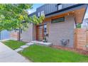 Contemporary home featuring a light brick exterior with a modern wood front door at 2280 W 42Nd Ave, Denver, CO 80211