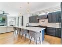 Bright kitchen with white marble countertops, dark cabinets, pendant lights, and stainless steel appliances at 2280 W 42Nd Ave, Denver, CO 80211