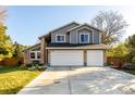 Charming two-story home with a well-manicured lawn and a two car garage at 8762 Mourning Dove Ln, Highlands Ranch, CO 80126