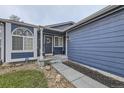 Close-up of the blue home's entrance with a decorative wreath and a well-kept walkway at 5550 E 130Th Dr, Thornton, CO 80241