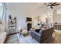 Bright living room featuring modern furniture, a fireplace, and vaulted ceilings at 5550 E 130Th Dr, Thornton, CO 80241