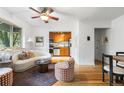 Inviting living room features an open floor plan, ceiling fan, hardwood floors, and view into kitchen at 2100 N Franklin St # 5, Denver, CO 80205