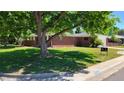 Brick ranch house with a lush lawn and mature trees at 2998 S York St, Denver, CO 80210