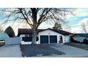 Charming single-story home featuring a two-car garage and mature tree at 2538 S Dover Way, Lakewood, CO 80227