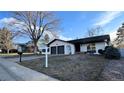 Charming single-story home featuring a two-car garage and mature tree at 2538 S Dover Way, Lakewood, CO 80227