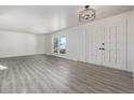 Bright living room with hardwood floors and double doors at 2538 S Dover Way, Lakewood, CO 80227