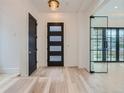 Light and spacious entryway with modern black door and glass partition at 521 Milwaukee St, Denver, CO 80206