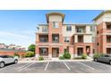 Charming brick and peach apartment complex with a well-maintained exterior and designated parking spots at 4100 Albion St # 614, Denver, CO 80216