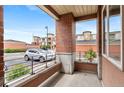 Inviting porch featuring brick columns and views of the well-maintained exterior and parking at 4100 Albion St # 614, Denver, CO 80216