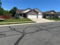 Charming two-story home with a three-car garage and a well-manicured lawn at 11237 W 55Th Ln, Arvada, CO 80002