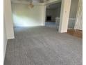 Spacious living room featuring neutral carpet, white walls, and a chandelier at 11237 W 55Th Ln, Arvada, CO 80002
