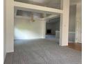 Spacious living room featuring neutral carpet, white walls, and a chandelier at 11237 W 55Th Ln, Arvada, CO 80002