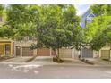 Charming row of townhomes with mature trees, garages, and well-maintained exteriors at 8243 S Fillmore Cir, Centennial, CO 80122