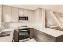 Contemporary kitchen featuring sleek countertops, stainless steel appliances, and modern cabinetry at 8243 S Fillmore Cir, Centennial, CO 80122