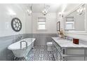 Elegant bathroom features a clawfoot tub, marble countertop, and stylish fixtures at 624 E 18Th Ave # 4, Denver, CO 80203
