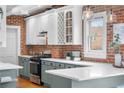 Charming kitchen with white quartz counters, stainless steel appliances, and decorative lighting at 624 E 18Th Ave # 4, Denver, CO 80203