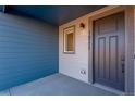 Close up of the exterior door featuring modern design and gray accents and visible unit number at 16777 W 94Th Way, Arvada, CO 80007