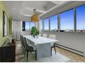 Bright dining room with floor to ceiling windows and an eye-catching city view at 3131 E Alameda Ave # 1302, Denver, CO 80209