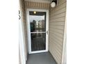 Close-up of a front glass door with white trim, showing access to a condo unit at 8645 Clay St # 400, Westminster, CO 80031