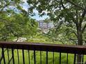 Exterior view from the balcony overlooking a grassy area with trees and a distant building complex at 8645 Clay St # 400, Westminster, CO 80031