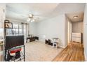 Bright and airy living room with large windows, light-colored walls, and a ceiling fan at 14937 E Security Way, Aurora, CO 80011