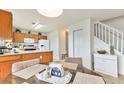 Bright dining area featuring a table and chairs adjacent to the kitchen and staircase at 4710 N Foxtail Dr, Castle Rock, CO 80109
