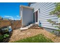 Cozy backyard with a private seating area, rock landscaping, green grass, and access to the home's entrance at 3678 Shadow Cir, Castle Rock, CO 80109