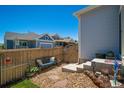 Secluded backyard featuring a wooden fence, comfortable bench, stone accents, and low-maintenance landscaping at 3678 Shadow Cir, Castle Rock, CO 80109