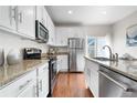 Modern kitchen featuring granite countertops, stainless steel appliances, and white cabinetry at 3678 Shadow Cir, Castle Rock, CO 80109