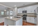 Modern kitchen featuring white cabinets, granite countertops, and stainless steel appliances at 3678 Shadow Cir, Castle Rock, CO 80109