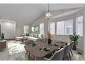 Bright living room and dining area featuring vaulted ceilings, neutral décor, and large windows at 3678 Shadow Cir, Castle Rock, CO 80109