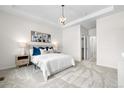 Serene bedroom with neutral tones, tray ceiling, and a chandelier light fixture at 3678 Shadow Cir, Castle Rock, CO 80109